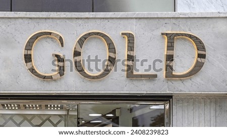 Gold 3d Sign With Glow at Marble Wall Luxury Jewellery Shop