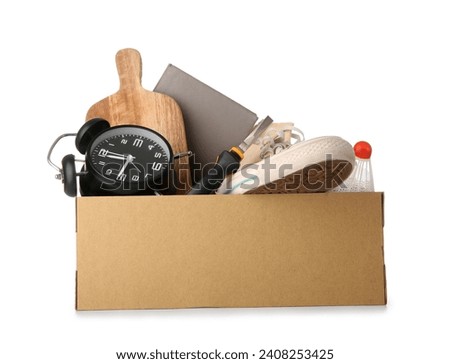 Box of unwanted stuff for yard sale isolated on white background Royalty-Free Stock Photo #2408253425