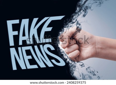 Aggressive fist punching fake news and fighting disinformation Royalty-Free Stock Photo #2408259375