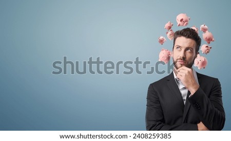 Young businessman with piggy banks around his head, he is thinking with hand on chin, financial planning and investments concept