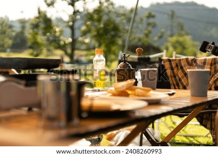 Food lover at Camping! Cooking food during camping at natural lake and mountain view background. Recreation and journey outdoor activity lifestyle.