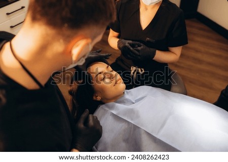 Plastic surgeon making facial injection in clinic. High quality photo