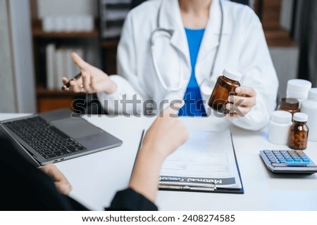Healthcare costs and fees concept.Hand of smart doctor used a calculator and smartphone, tablet for medical costs at hospital in morning light
