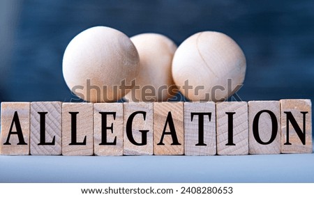ALLEGATION - word on wooden blocks on dark blue background. Business concept Royalty-Free Stock Photo #2408280653
