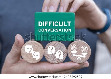 Man holding multi-colored blocks sees inscription: DIFFICULT CONVERSATION. Difficult conversation concept. Serious talk in sensible subjects at work or relationship, discuss personal issues conflict. Royalty-Free Stock Photo #2408292509