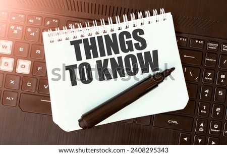 White paper sheet with text THINGS TO KNOW on the black laptop