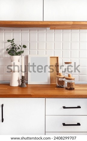 Mock up poster frame in kitchen interior on empty green color wall background.