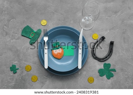 Beautiful table setting for St. Patrick's Day celebration on grey background