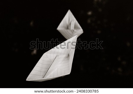 two paper boats are sailing