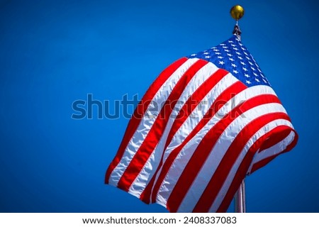 USA flag, symbolizing national pride and unity. Explore high-quality images capturing the essence of the American flag against diverse backgrounds. Elevate your creative projects with the Stars and