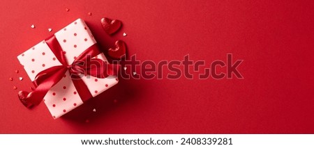 Valentine's day gift. Banner design with present box and hearts on red background.