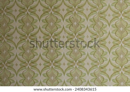 Old wallpaper on the wall. Old wallpaper for texture or background. Royalty-Free Stock Photo #2408343615
