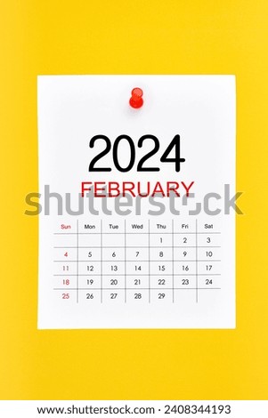 February 2024 calendar page with push pin on yellow background. Royalty-Free Stock Photo #2408344193