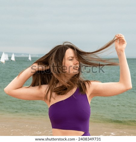 Portrait of a beautiful young woman with long hair on the beach