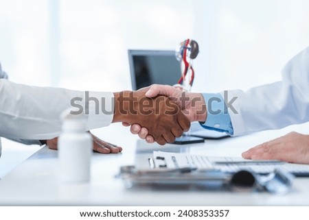 close-up handshake between two individuals, doctor and other casual shirt. doctor-patient relationship, agreement on treatment plan,  conclusion of medical consultation. Royalty-Free Stock Photo #2408353357
