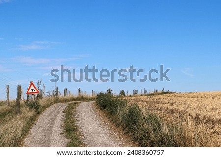 Airplanes have priority - image of a dirt road with a traffic sign giving priority to airplanes