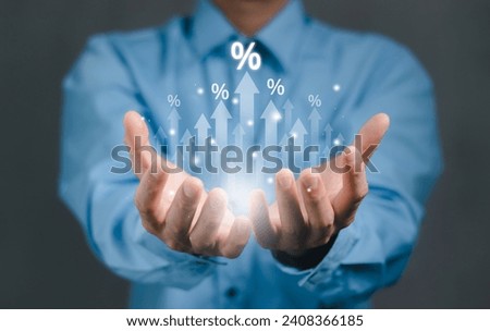 Businessman hand with rising arrow and percentage icon. Interest rate and dividend concept, Business finance and money concept, Investment growth, Return on stocks and mutual funds, profitability,
