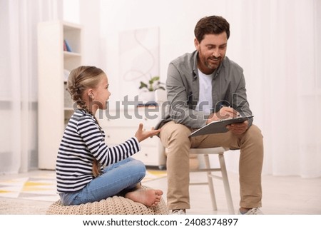 Dyslexia treatment. Therapist working with girl in room