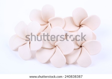 Frangipani flower made of ceramic isolated on white