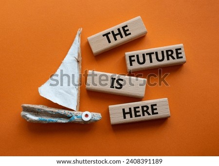 The future is here symbol. Concept words The future is here on wooden blocks. Beautiful orange background with boat. Business and The future is here concept. Copy space.