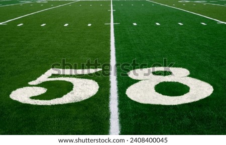 Football field symbolizing the big game in 2024 Royalty-Free Stock Photo #2408400045