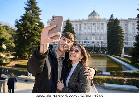 A Blissful Couple Takes a Romantic Selfie Amidst the Timeless Beauty of the City, Creating Cherished Memories of Their European Honeymoon Adventure