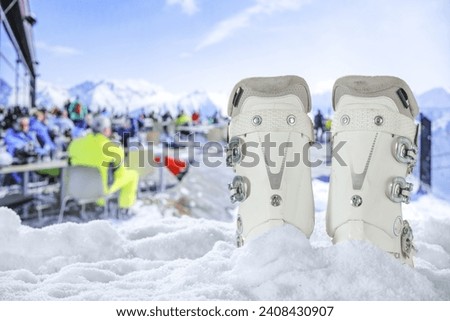 Ski boots on snow and winter time. Free space for your decoration. 