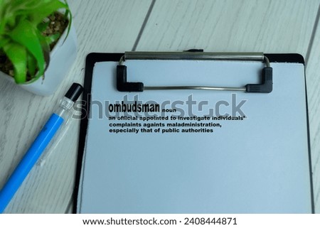 Concept of Definition of Ombudsman write on paperwork with a meaning isolated on wooden background.