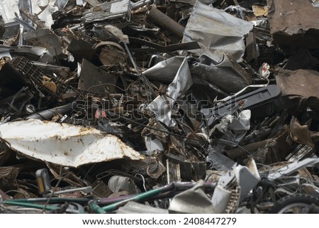 scrap iron and scrap metal, waste and garbage on a junkyard Royalty-Free Stock Photo #2408447279