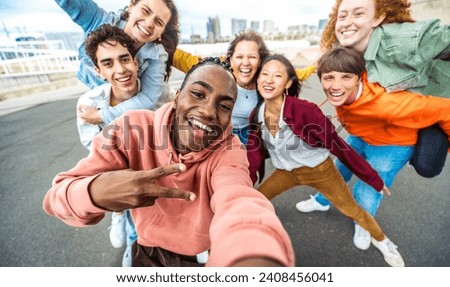 Happy multiracial friends taking selfie outside - Group of young people with arms up smiling at camera - Youth community with guys and girls hugging together