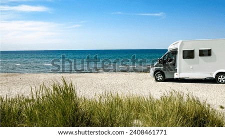 Camper on a beach by the sea Royalty-Free Stock Photo #2408461771