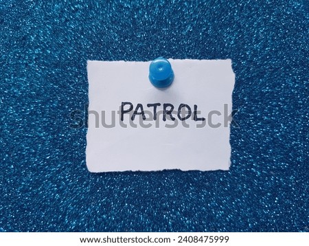 Patrol writing on a blue background.