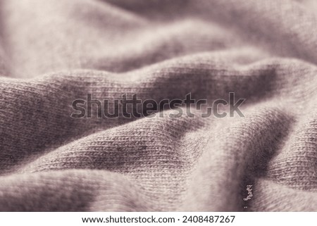 Textile background soft cashmere texture.New wool products with label.  Royalty-Free Stock Photo #2408487267