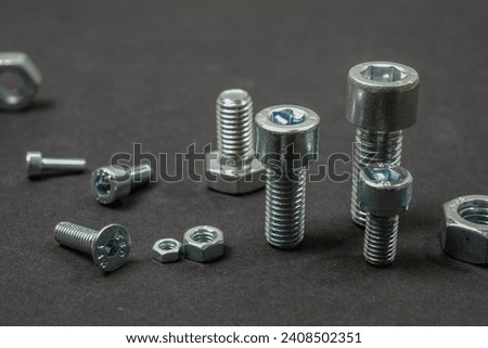 Metal bolts and nuts of different sizes on the table