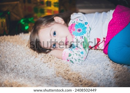 Happy little smiling girl with christmas gift box. Little girl with Christmas gifts near a Christmas tree at home. High quality photo