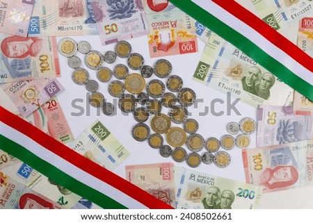 new bank notes of mexican peso and shape of Mexico made with coins background. 20, 50, 100, 200, 500 pesos Royalty-Free Stock Photo #2408502661