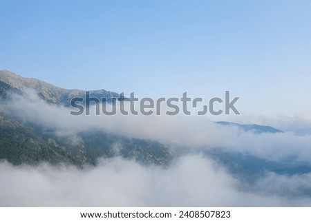 The green countryside under the clouds in Europe, France, in the Pyrenees, in summer, on a sunny day.