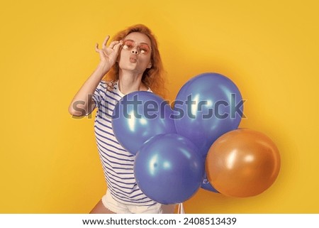 party girl with balloon in sunglasses. happy young girl hold party balloons in studio.