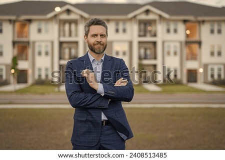 photo of cheerful man broker. man broker at the house. man broker in the suit. man broker outdoor