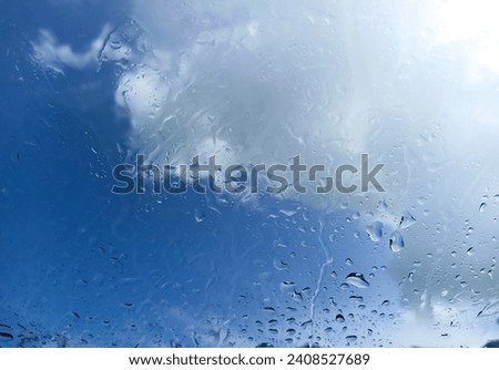 drizzle on the windshield of the car against the clear sky