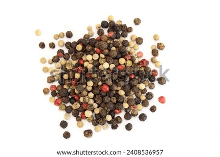 Mixed of peppers on a white background. Pepper mix. Black, red, white, and green peppercorns on a white background.  top view. Royalty-Free Stock Photo #2408536957