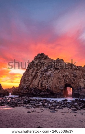 Pfeiffer Beach at sunset in Big Sur during winter creating amazing vibrant landscape Royalty-Free Stock Photo #2408538619
