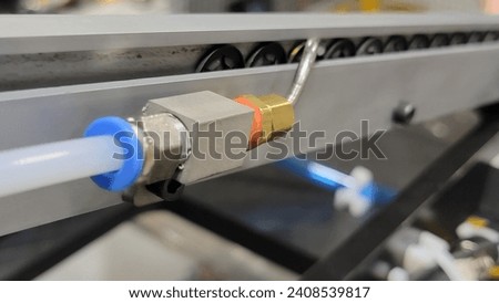 pneumatic tubing blow off feed track Royalty-Free Stock Photo #2408539817