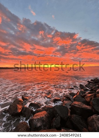Sunrise in Capitola, California. Beautiful Rocky shore with the sunrise in the distance. Royalty-Free Stock Photo #2408549261