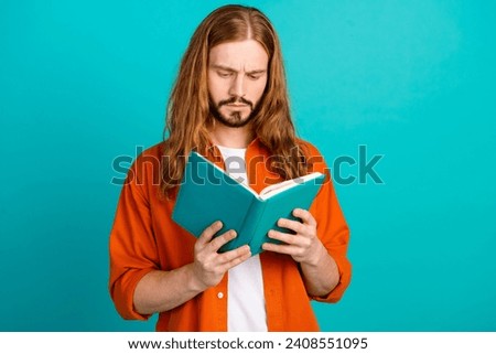Photo of intelligent focused guy with wavy hairdo wear stylish outfit read interesting book isolated on turquoise color background