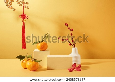 Tangerines, two wooden platforms, a flower vase and Tet decorations are displayed on a yellow background. Ideal space for displaying products during Tet.