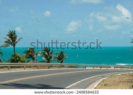 Picture of palm trees and a sailboat in a beautiful landscape