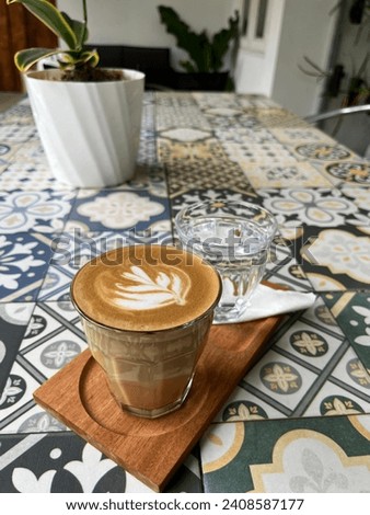 This is a picture of Latte Art on top of Hot Capuccino. Latte art is the design you see on top of (typically) drinks like lattes, chocolate, cappuccinos, and similar milk-and-espresso beverages.