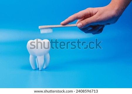 Tooth and eco tooth brushes on a blue background. Concept of dental examination of teeth, health and dental hygiene. Prevention of caries and tartar teeth.