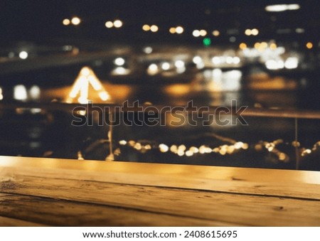  background with wooden table looking out to bokeh lights 